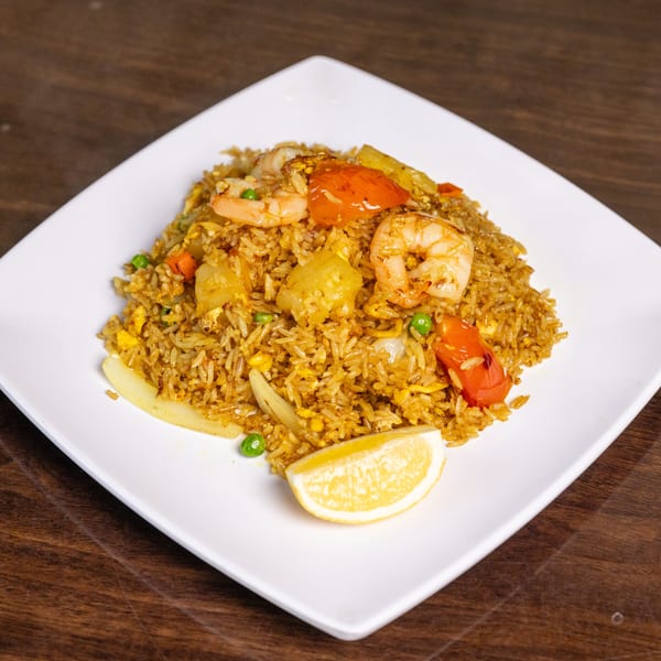 Thai Palace MD's pineapple fried rice with shrimp, vegetables, and a lemon wedge.
